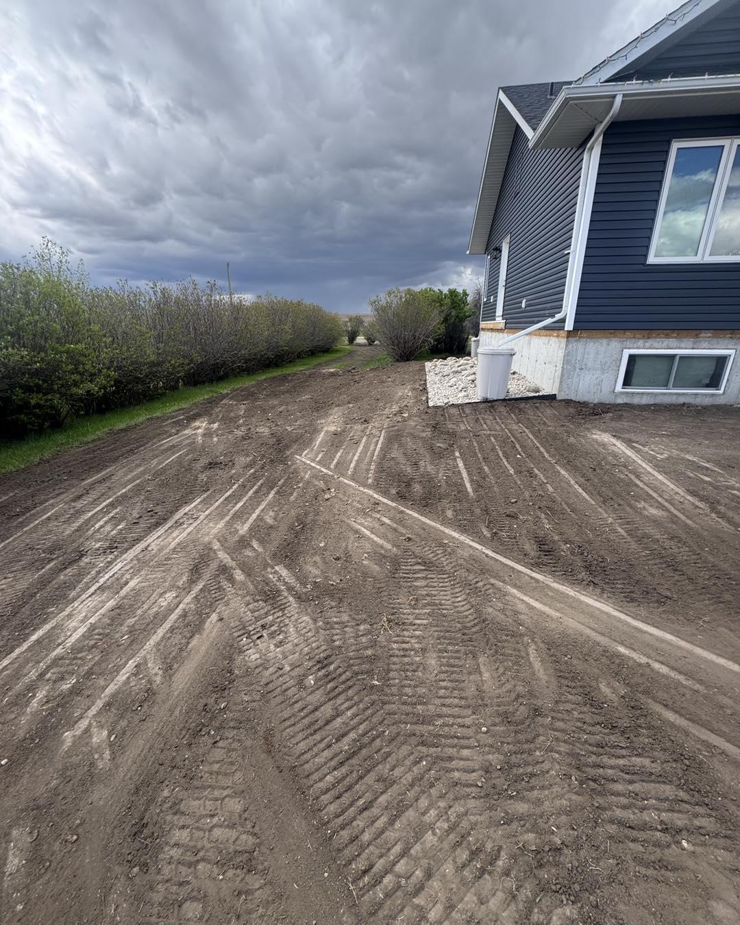 Commercial excavation and site preparation in Strathmore - professional Bobcat skid steer grading large commercial building site