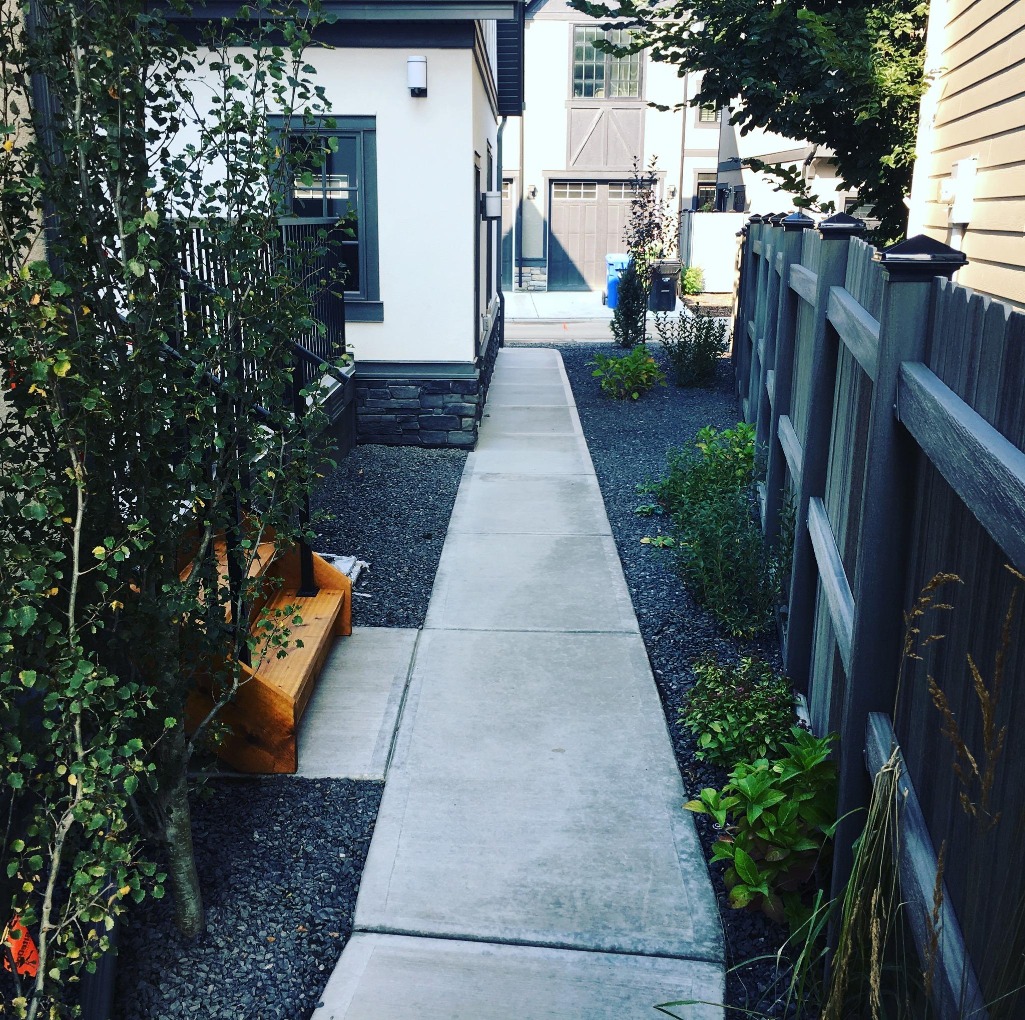 Beautiful custom patio and landscaping in Strathmore - natural stone installation with professional outdoor lighting and mature plantings